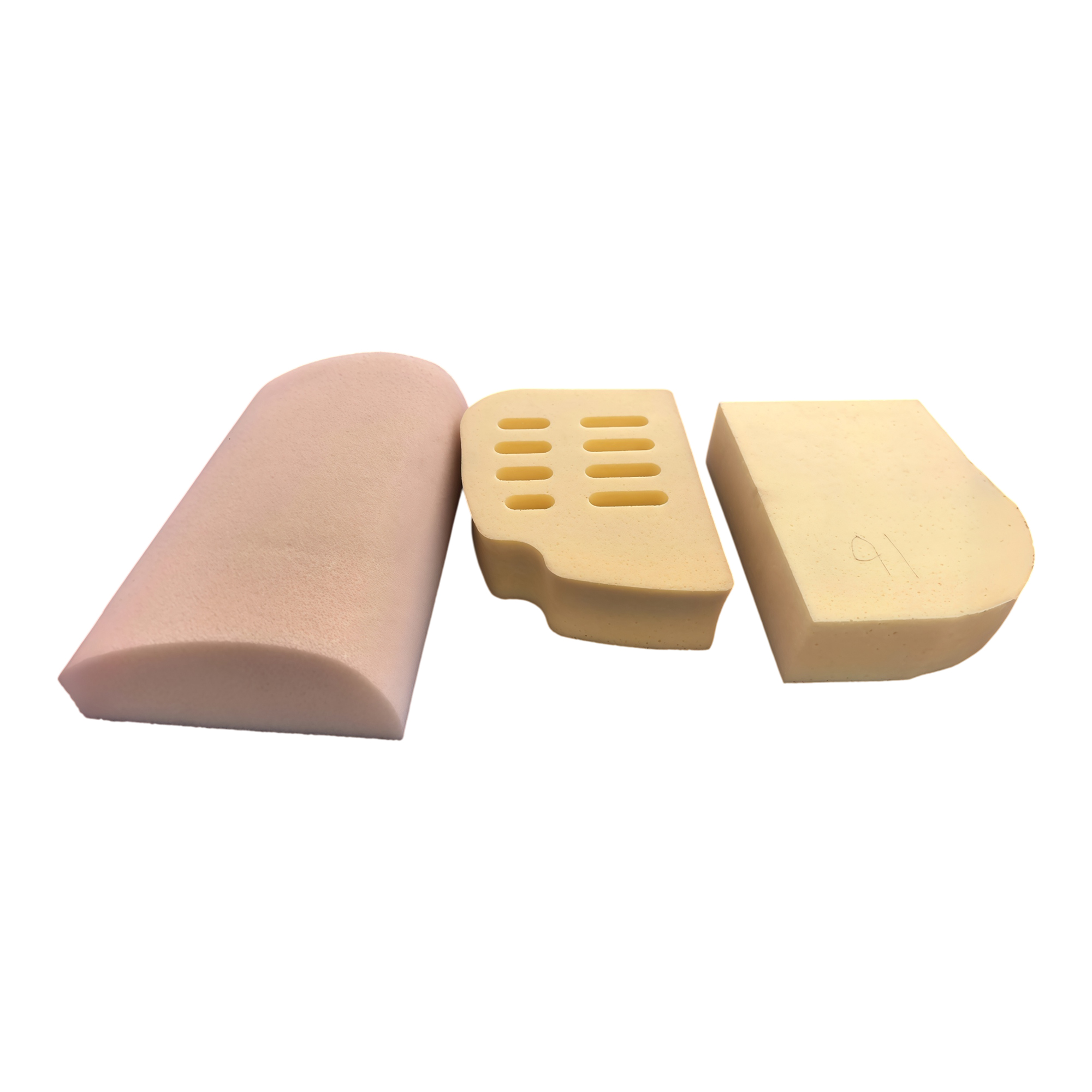 Representative children’s products foam: a pink half-round block, a cream block with eight slots and a cream block with a curved edge